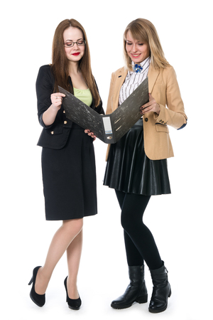 Two young business women in full growth isolated on white backgroundの写真素材