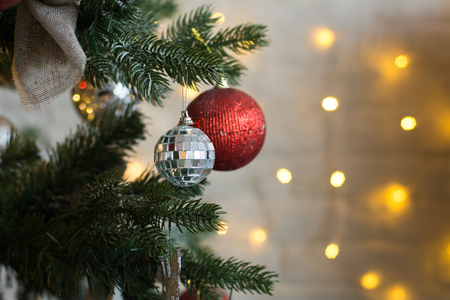 Close-up of the balls on a Christmas tree. Background of burning garlandsの写真素材