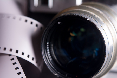 Close-up lens with old camera. Camera on the background of a negative filmの写真素材