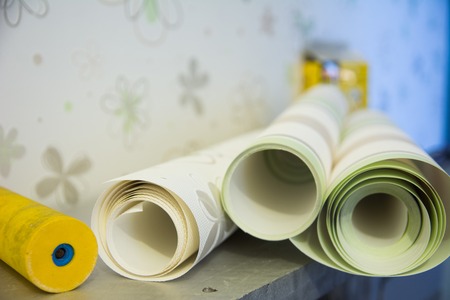 Wall-papers vinylic for repair of a room and a roller for a wallpaperの写真素材