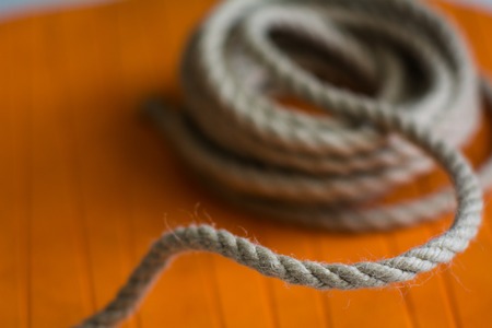 Roll of rough rope against the background of an orange circle.の写真素材