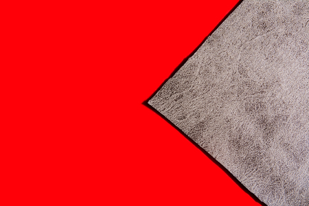 Background of a gray cloth on a red surface. New fabric with abstract pattern and red backgroundの写真素材