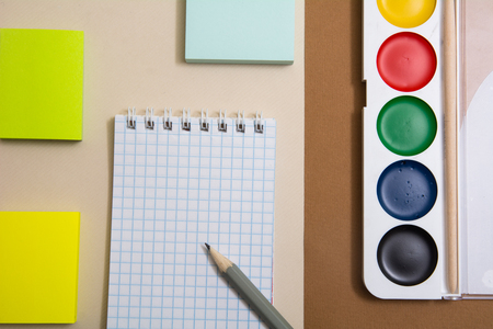 Notepad with pencil sticky paper for snakes and watercolor paints. Blocks of paper for recording on a delimited surfaceの写真素材