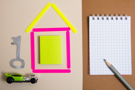 House of counting sticks car key to the apartment and a notebook with a pencil. Dream project of your houseの写真素材
