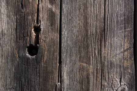 Background of an old rough board with knots and furrows. Door from vintage boardsの写真素材