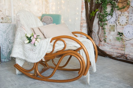 Background with rocking chair with pillows in a rustic style.の写真素材