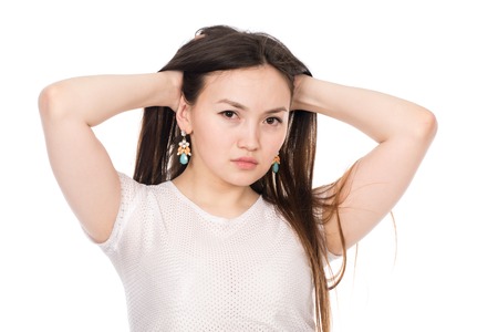 Portrait of an Asian woman with long hair isolated over white backgroundの写真素材