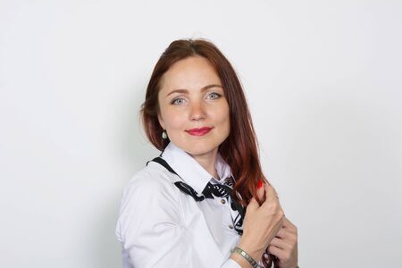 Portrait of a beautiful woman looking at camera over white background.の写真素材