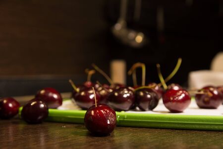 Background of dark cherries on the kitchen table.の写真素材