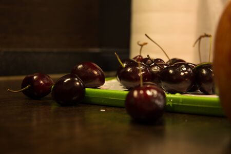 Background of dark cherries on the kitchen table.の写真素材