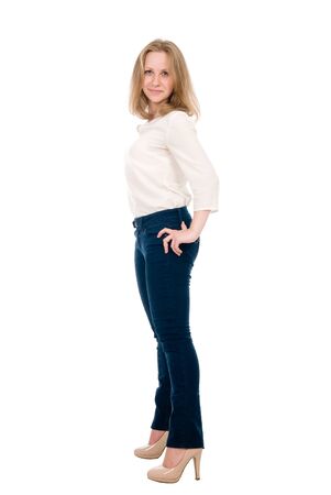 Portrait of a cheerful young woman in jeans isolated over a white background.の写真素材