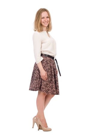 Fashion portrait young woman in skirt posing full length isolated over white backgroundの写真素材
