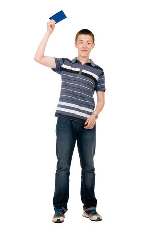 Happy casual young man in his raised hand holds a blue clean sheet. Isolated on white backgroundの写真素材