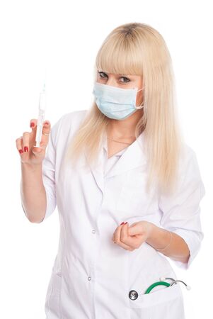 Masked nurse with syringe in hand. Doctor with vaccine isolated over a white backgroundの写真素材