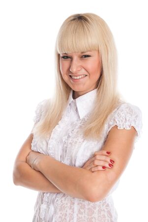 Portrait of a smiling young blonde with arms crossed isolated over a white backgroundの写真素材