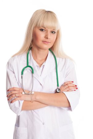 Nurse in a white coat with a stethoscope arms crossed. Young doctor isolated on a light backgroundの写真素材