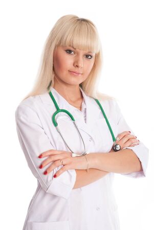 Nurse in a white coat with a stethoscope arms crossed. Young doctor isolated on a light backgroundの写真素材