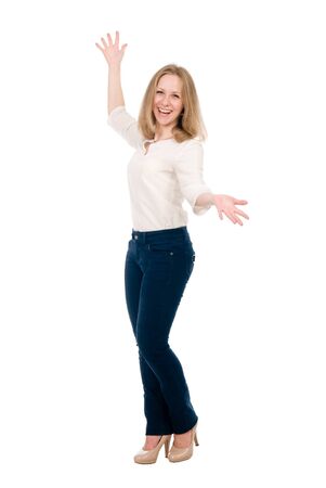 Portrait of a cheerful young woman in jeans with hands side isolated over white background.の写真素材