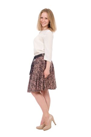 Fashion portrait young woman in skirt posing full length isolated over white backgroundの写真素材