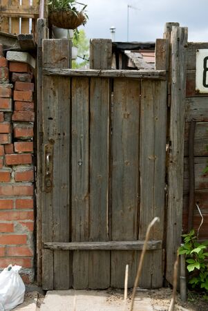 Background old wooden door, brick wall and trash bags. Village slumsの写真素材