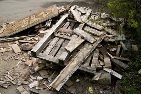 Background of sawn birch boards, trash and an old door piled in a pile.の写真素材