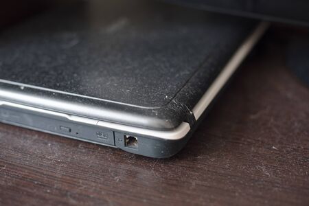 Dust on a wooden surface and laptop. Dirty background to be wiped.の写真素材