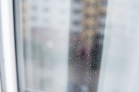 Background view from a dirty window on the house opposite. Virus isolation at home.の写真素材