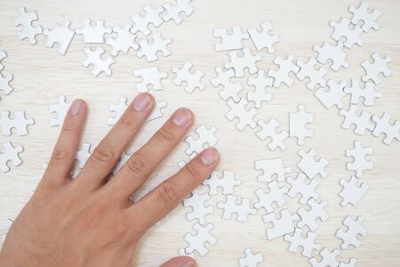 White jigsaw puzzle that has been placed on a desk