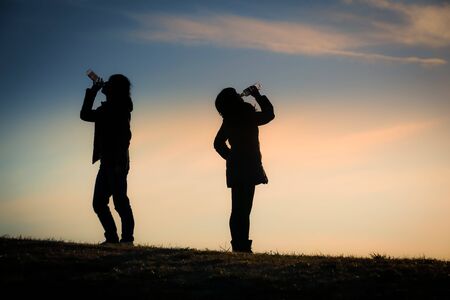 Men and women who drink the water in the twilight of the hill