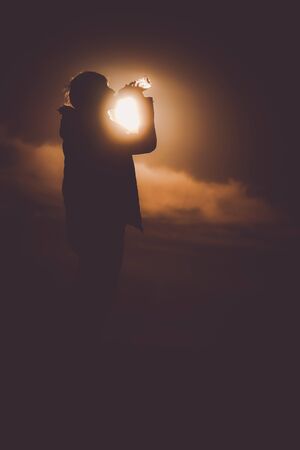 Men who drink the water in the twilight of the hillの写真素材