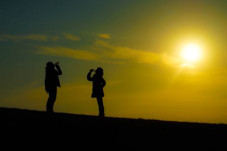 Men and women who drink the water in the twilight of the hill