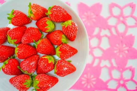 Frozen strawberries and white dishesの写真素材