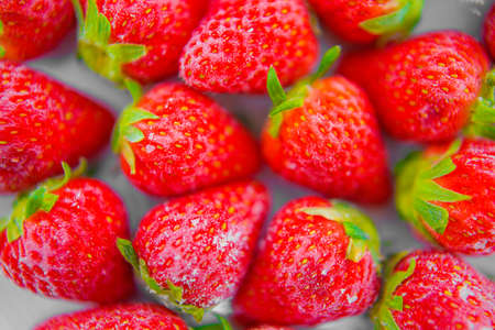 Frozen strawberries and white dishesの写真素材