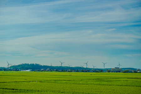 Rural landscape with wind power. Shooting Location: Akita