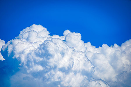 Close view of cumulus clouds and blue sky.の写真素材