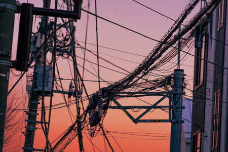 Pale evening sky and an alley lined with electric wires. Shooting Location: Kohoku Ward, Yokohama Cityの写真素材
