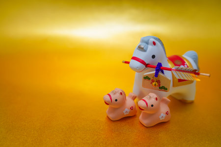 Horse and horse clay bells on a gold background. Shooting Location: Kanagawa Ward, Yokohama Cityの写真素材