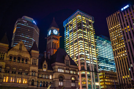 Clock tower and skyscrapers at night. Shooting Location: Toronto