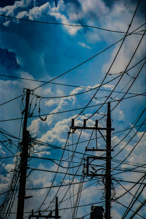 Electric wires entangled in the summer sky. Shooting Location: Kohoku Ward, Yokohama Cityの写真素材