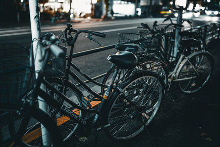 Bicycles lined up on the street at night.の写真素材