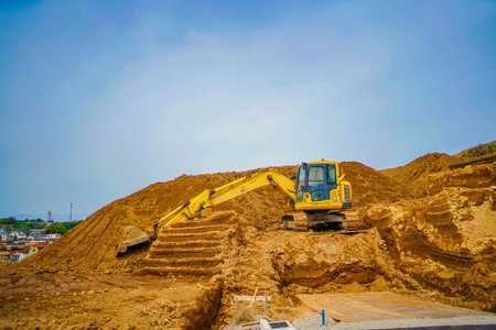 Construction machinery digging earth and sand. Shooting Location: Kohoku Ward, Yokohama Cityの写真素材
