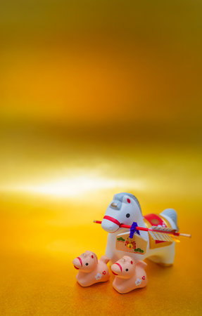 Year of the Horse parent and child figurine on a gold background. Shooting Location: Kanagawa Ward, Yokohama Cityの写真素材