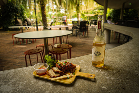 Bottled beer and food on the terrace. Shooting Location: Singaporeの写真素材