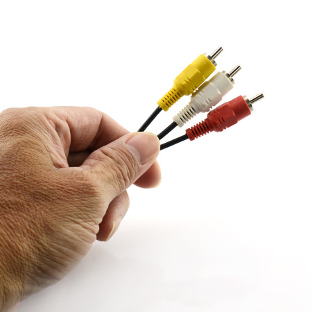 Male hand holding audio and video cinch connectorの写真素材
