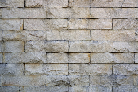 Close up of modern style design decorative uneven cracked real stone wall surface with cement...
