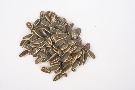 Edible sunflower seeds on a white background taken above