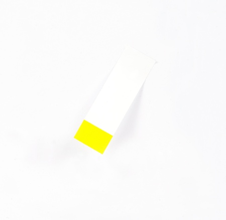 blank yellow memo paper isolated on whiteの写真素材