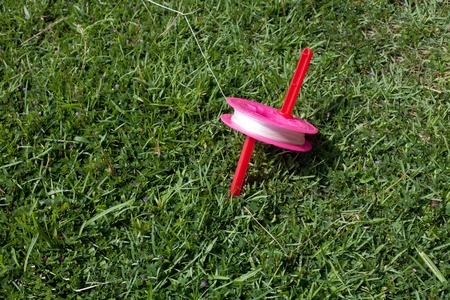 bright kite thread on the grassの写真素材