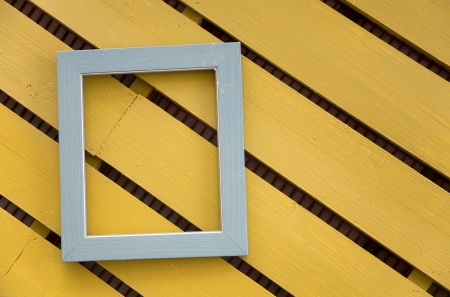 photo frame on color wood wallの写真素材