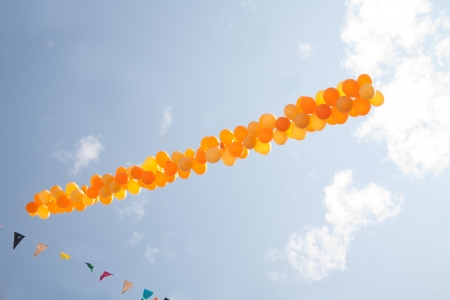 Orange balloons  on sky backgroundの写真素材